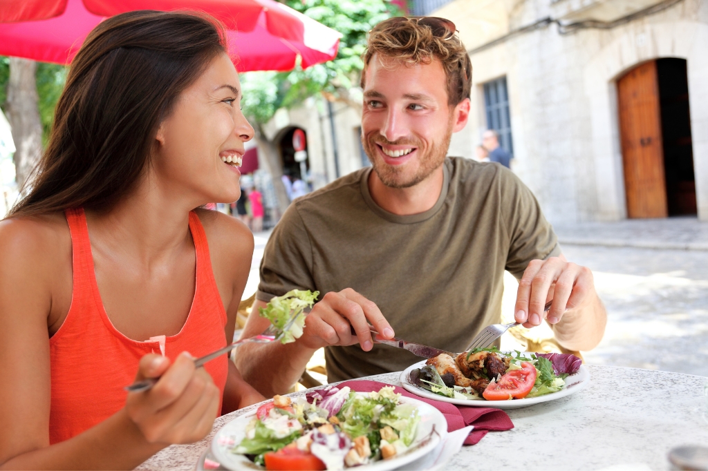 Happy couple eating in spanish restaurant