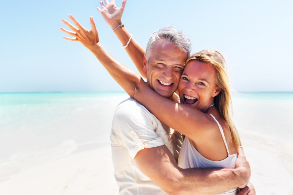 Happy adult couple on the beach
